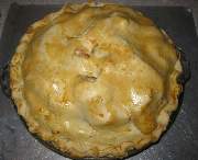 The apples in the finished form of a pie are now ready to eat.